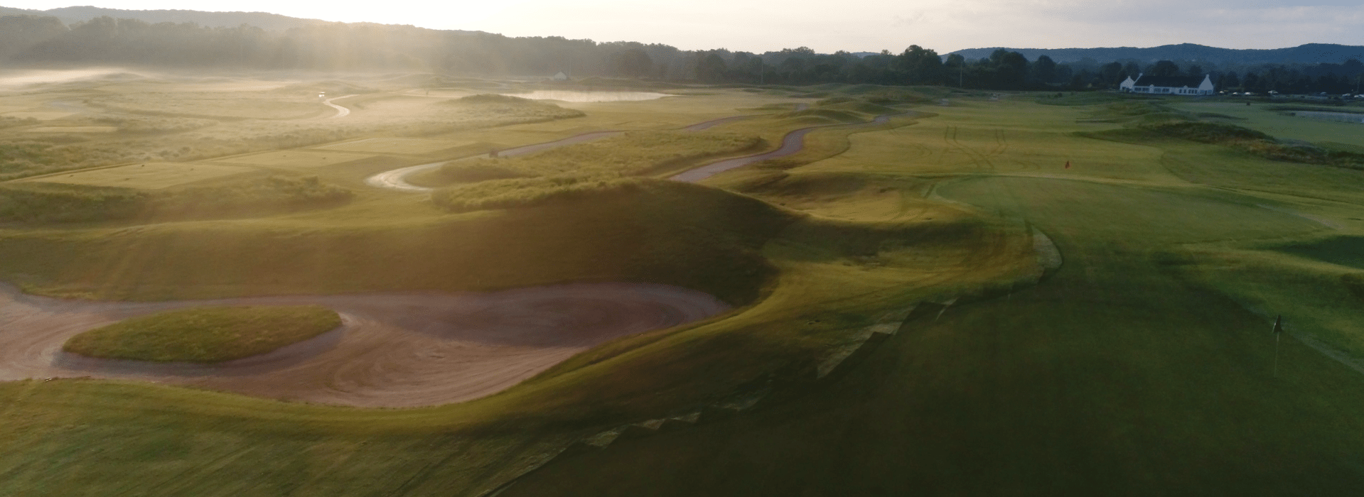 Image of golf ball on tee on grass.