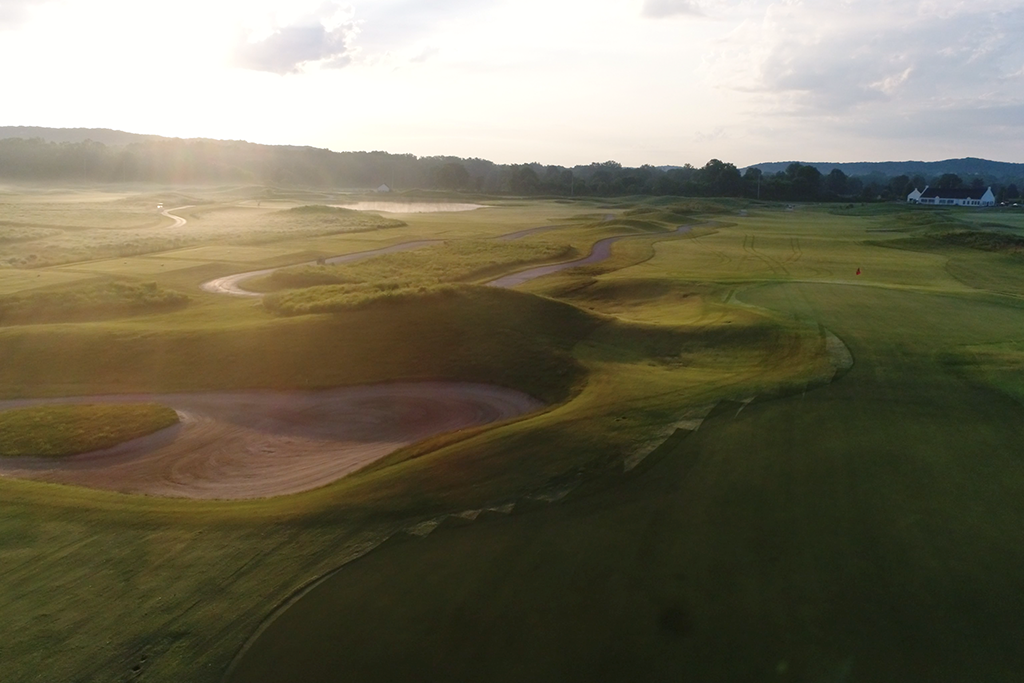 Golf course at sunrise with bunkers